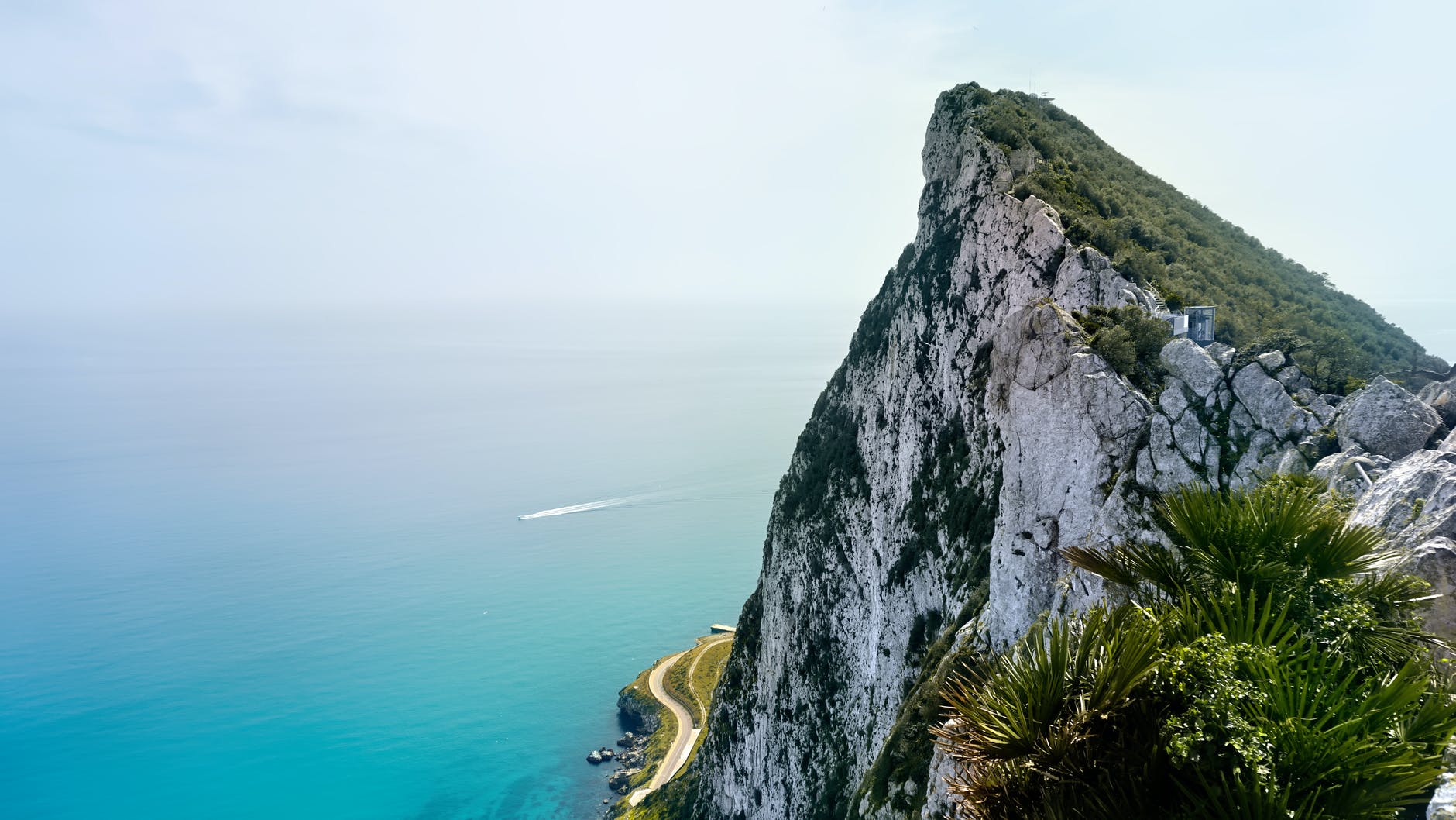 gray rocky mountain beside blue sea